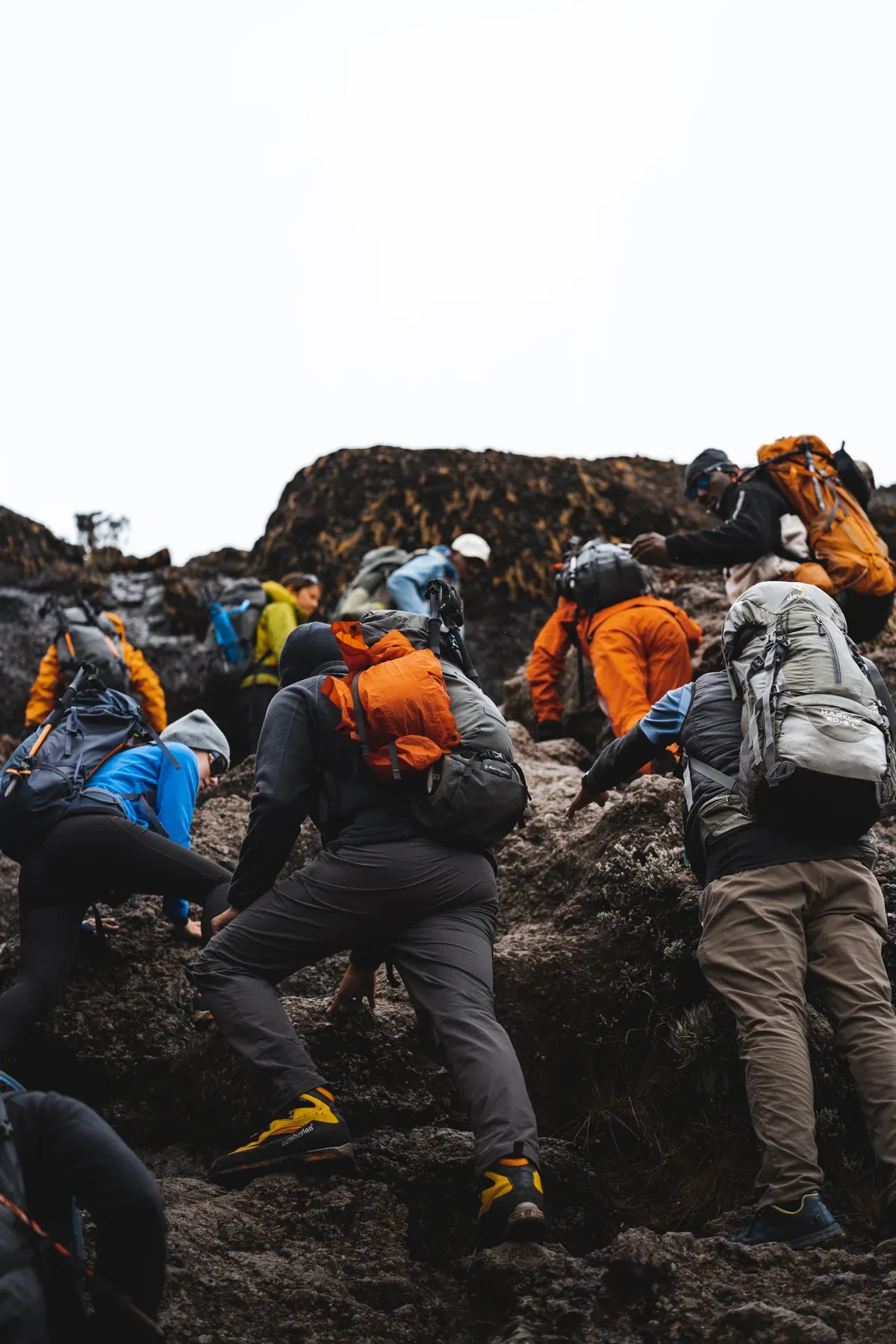 Climbers using their hands on the Barranco Wall, the steep scramble on Kilimanjaro climbing tours by the Machame and Lemosho routes