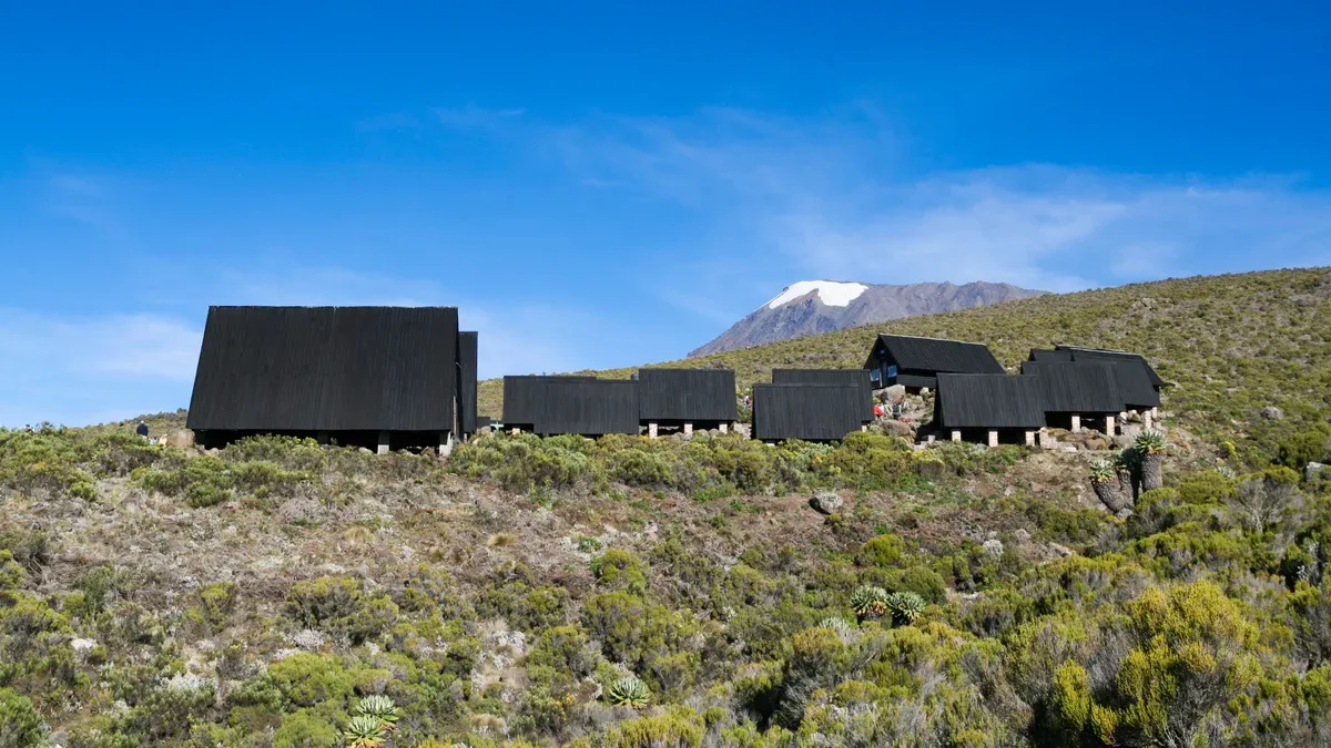 The black wooden huts of Horombo Hut on the moorland below Kibo, the second night on Kilimanjaro climbing tours by the Marangu Route